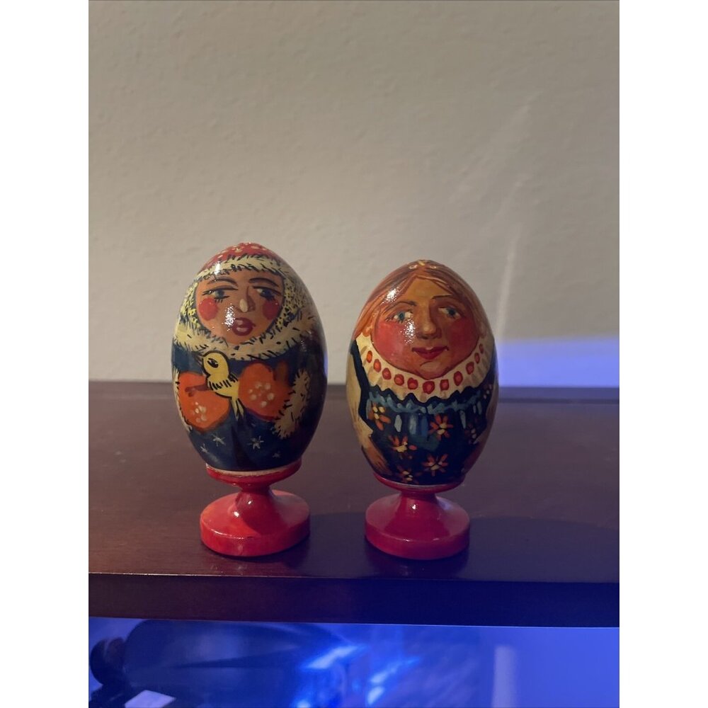 Hand-Painted Wooden Russian Folk Art Egg Figurines On Red Stands